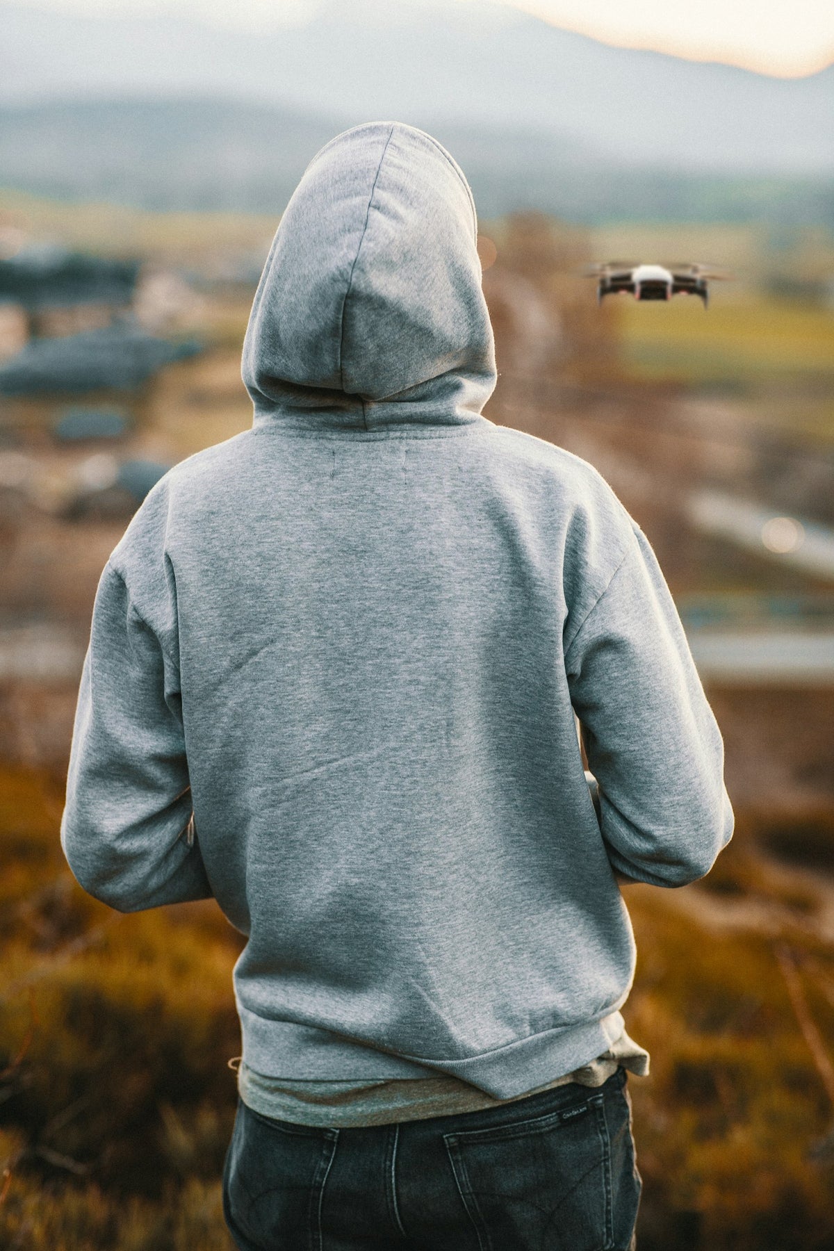 Man wearing a grey pullover hoodie