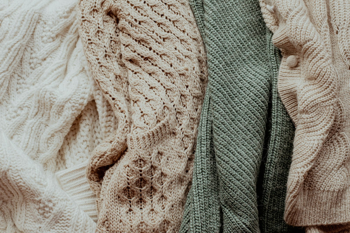 Pile of knit sweaters